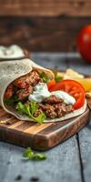 Savory meat wrap with fresh vegetables and sauce served on a wooden cutting board in a cozy setting photo