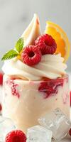 Delicious dessert with cream, raspberries, and a hint of citrus served in a chilled glass photo