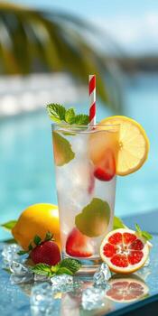 Refreshing summer drink with fruits and mint by the poolside on a sunny day photo