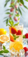 Refreshing summer drink with strawberries and citrus fruits served over ice outdoors photo