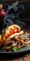 Delicious grilled meat sandwich served with crispy fries and garnished with fresh herbs on a wooden table photo