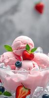 Delicious strawberry ice cream served in a glass bowl with fresh berries and mint leaves on a bright summer day photo