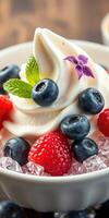 Frozen yogurt topped with fresh berries and mint served in a bowl photo