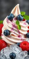 Delicious swirl of creamy soft serve topped with fresh blueberries and raspberries, served with mint leaves on ice photo