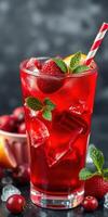 Refreshing summer drink with red fruits served in a tall glass at a vibrant party setting photo