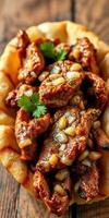 Delicious spicy grilled meat served on a warm tortilla with fresh herbs photo