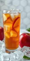 Refreshing iced apple tea with fresh apple slices and ice cubes in a tall glass photo