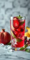 Refreshing summer beverage with fresh fruits and ice served in a tall glass on a marble countertop photo