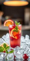 Refreshing summer drink garnished with fruit and mint served over ice in a cozy setting photo