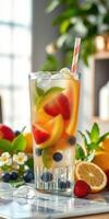 Refreshing fruit beverage with colorful slices and mint, served in a tall glass during bright daylight photo