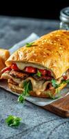 Delicious sandwich featuring grilled chicken, cheese, and fresh vegetables served on a toasted sesame bun photo