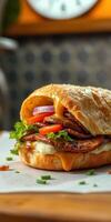 Delicious sandwich with layers of vegetables, cheese, and roasted meat on a wooden table photo