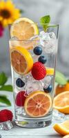 Refreshing fruit-infused drink with ice and vibrant colors on a table photo