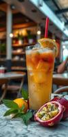 Refreshing tropical drink garnished with lemon and surrounded by fresh fruit in a modern cafe setting during daytime photo