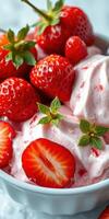Fresh strawberries and pink whipped cream dessert in a bowl with mint leaves on a light background photo