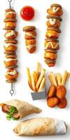 Delicious assortment of snacks including fried items and wraps presented on a clean surface photo