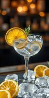 Refreshing cocktail garnished with lemon slices and ice on a bar counter in a dimly lit setting during evening hours photo