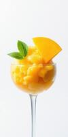Refreshing mango sorbet served in a glass with mint leaves and a slice of fresh mango photo