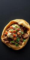 Delicious pita filled with spiced meat, onions, and fresh vegetables paired with a creamy sauce photo