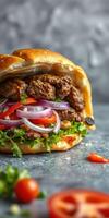 Mouthwatering burger topped with fresh vegetables served on a rustic grey background photo