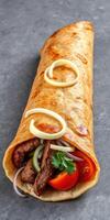 Delicious wrap filled with tender beef, fresh vegetables, and flavorful sauces, served on a simple grey background photo