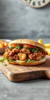 Deliciously crafted chicken sandwich with fresh toppings and side of fries served on a wooden board photo