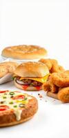 Delicious fast food spread with burger, chicken nuggets, bread, and pizza on a white background photo