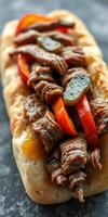 Grilled steak sandwich with colorful bell peppers and seasoning garnishing on a soft roll photo
