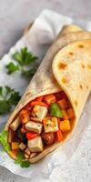 Tasty wrap filled with fresh vegetables and tofu on a light background photo