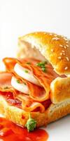 Delicious sandwich featuring layers of ham, cheese, and sauce on a sesame seed bun with fresh herbs photo