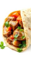Delicious wrap filled with tender meat, colorful vegetables, and fresh herbs prepared on a clean white surface photo