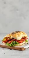 Gourmet sandwich with fresh vegetables and savory fillings on wooden board photo