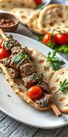 Delicious skewers of grilled meat served with naan and cherry tomatoes on a rustic wooden table photo