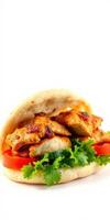 Delicious grilled chicken sandwich on soft bread with fresh vegetables and herbs ready to enjoy photo