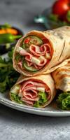 Delicious wraps filled with layers of deli meat, fresh vegetables, and cheese on a rustic plate photo