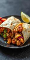 Deliciously crafted burritos filled with vibrant ingredients served on a black plate photo