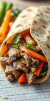 Delicious beef wrap filled with fresh vegetables and herbs on a wooden table photo