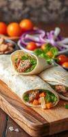 Delicious wraps filled with meat and fresh vegetables served on a wooden board with side garnishes photo