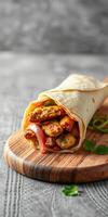 Delicious chicken wrap filled with fresh vegetables and flavorful sauce on a wooden cutting board photo