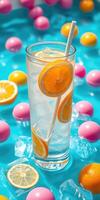 Refreshing citrus drink garnished with orange slices amid colorful decorative eggs on a bright aqua background photo
