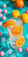 Refreshing citrus drink with orange slices and colorful candies on a vibrant blue background photo