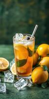 Refreshing lemon iced tea with ice cubes and fresh lemons on a green background in a cozy setting photo