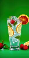 Refreshing citrus drink with ice and fruits served on a vibrant green background photo