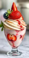 Delicious dessert featuring fresh strawberries and whipped cream served in a glass bowl photo