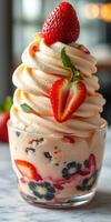 Delightful dessert with swirls of cream, fresh strawberries, and colorful toppings served in a glass cup photo