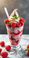 Delicious raspberry parfait with soft serve and mint leaves served on a marble table photo