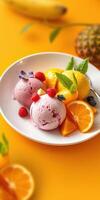 Colorful fruit and ice cream dessert served in a bowl with fresh fruit and mint leaves on a bright background photo