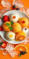 Colorful dessert bowl with ice cream and fresh fruits on bright orange backdrop photo
