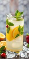 Refreshing citrus and mint beverage served in a tall glass on a wooden surface with garnishes photo