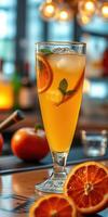 Refreshing citrus drink garnished with fresh mint and orange slices in a vibrant bar setting photo